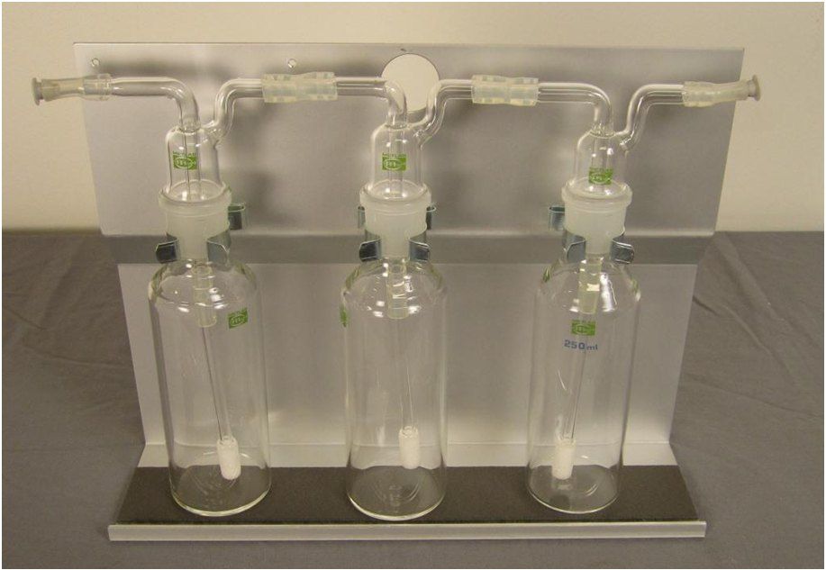 Three absorption bottles in a bottle rack