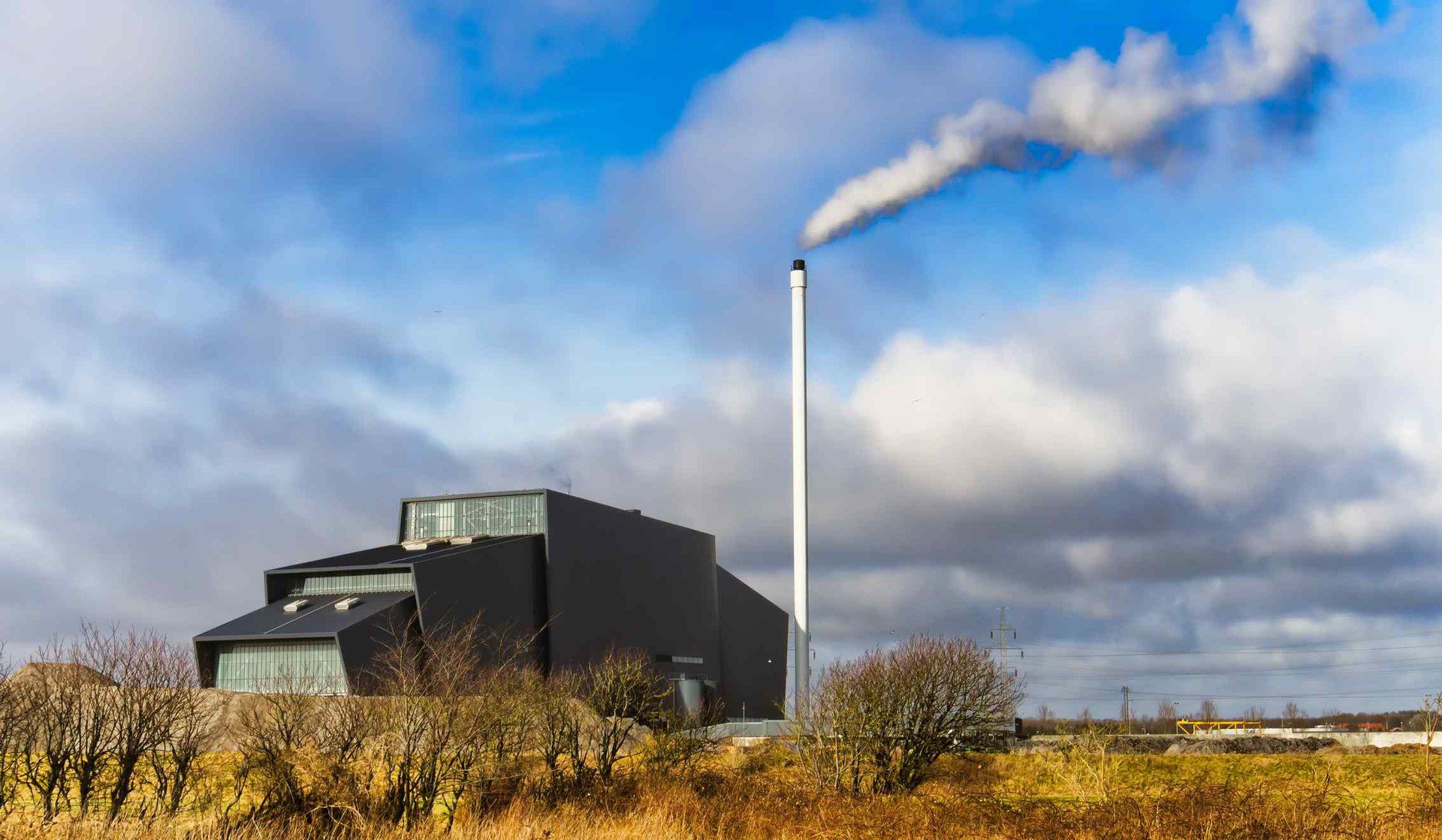 Modern heating plant with a stack against a blue sky