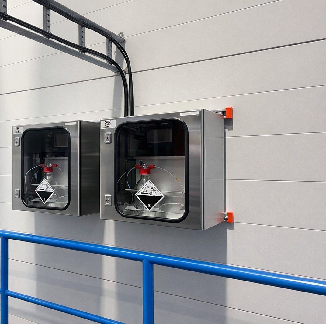 Two C14G2 samplers mounted on a wall at a waste-to-energy plant