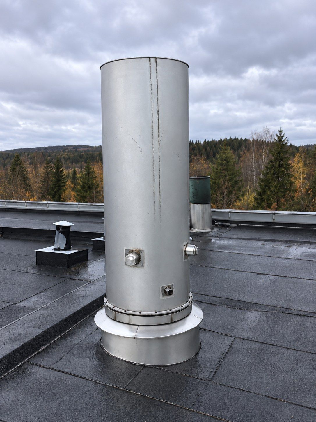 Stainless steel stack on a roof with two 3-inch ports at 90 degrees and a smaller port for flow measurement lower down