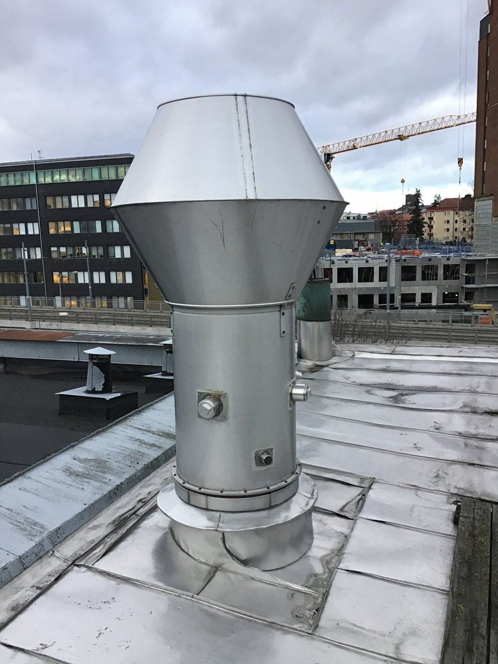 Ventilation stack on a roof with two 3-inch ports at 90 degrees and a smaller port lower down